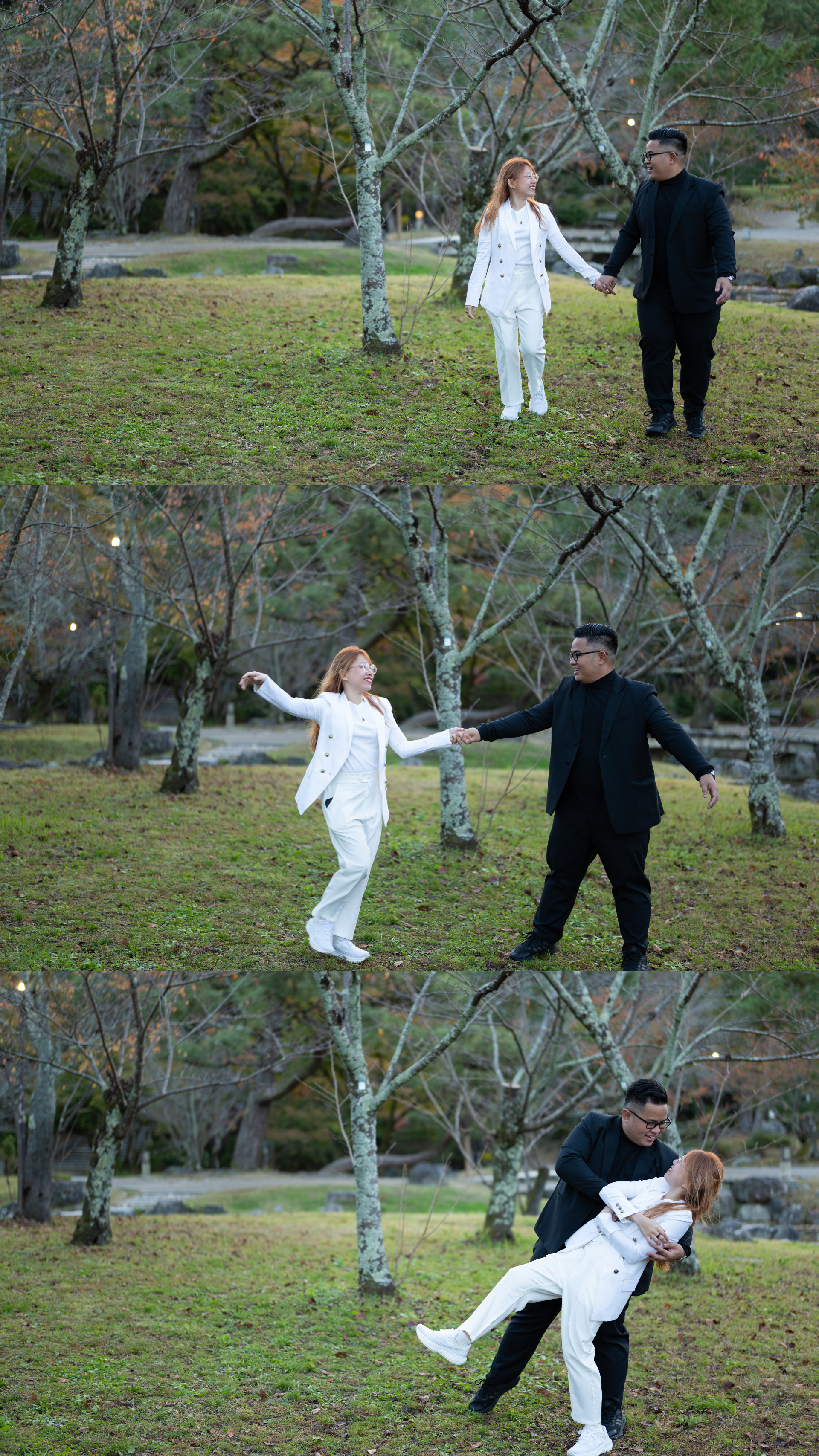 Couple playfully spinning and lifting each other on a green lawn in a park.