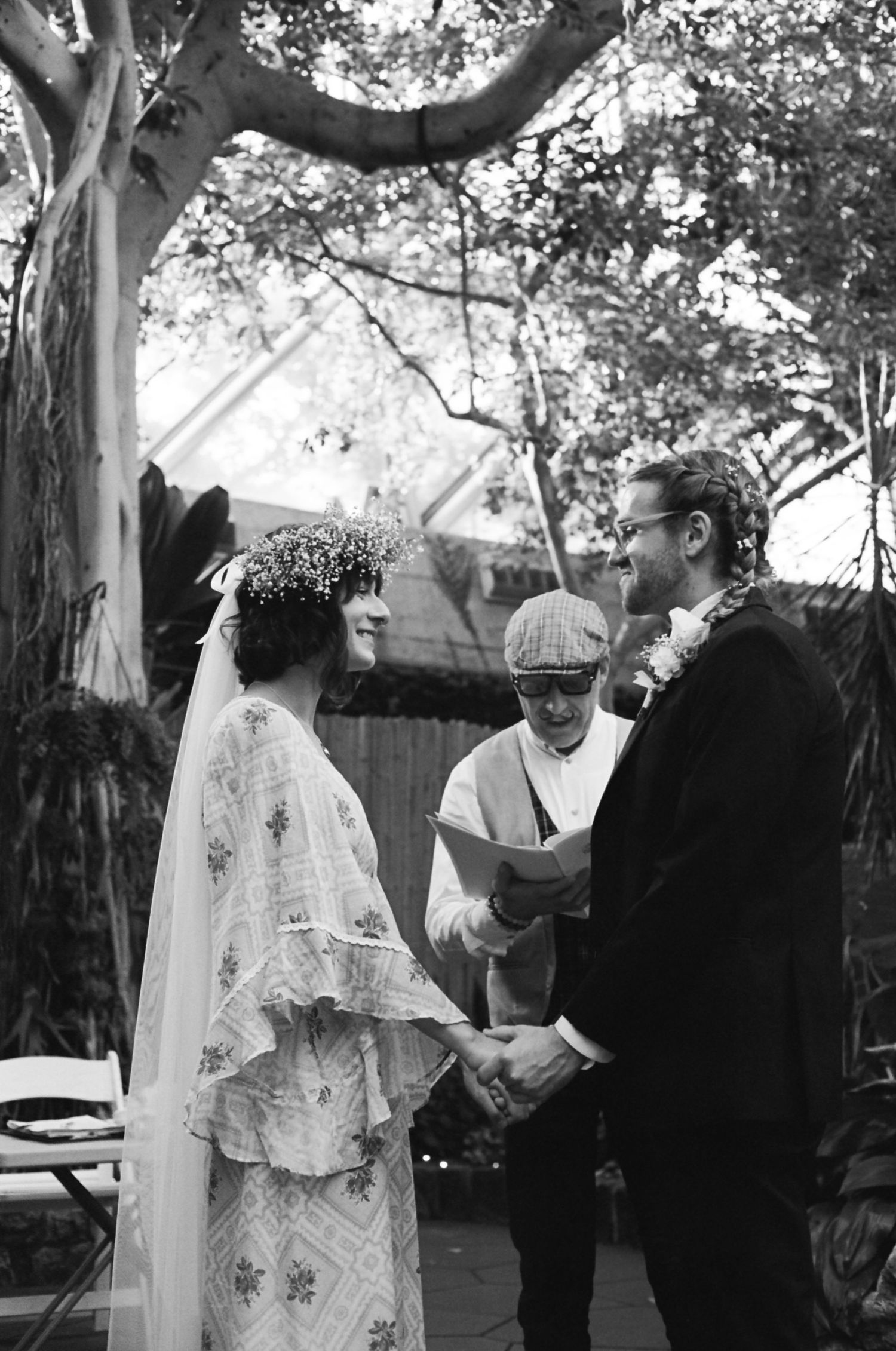 Outdoor mountain wedding ceremony with guests seated overlooking a stunning mountain vista.