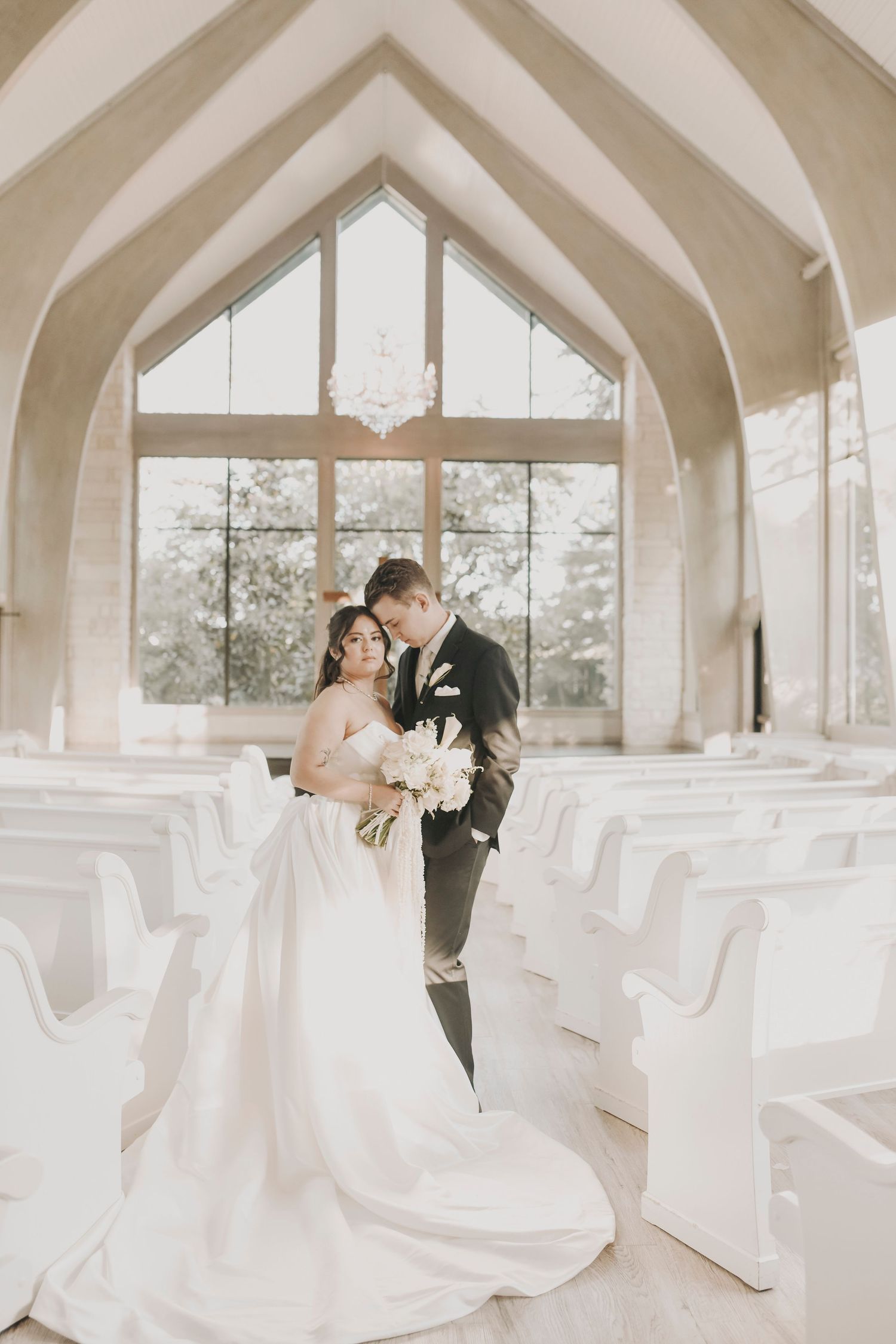 Luxury wedding portrait in a bright modern chapel