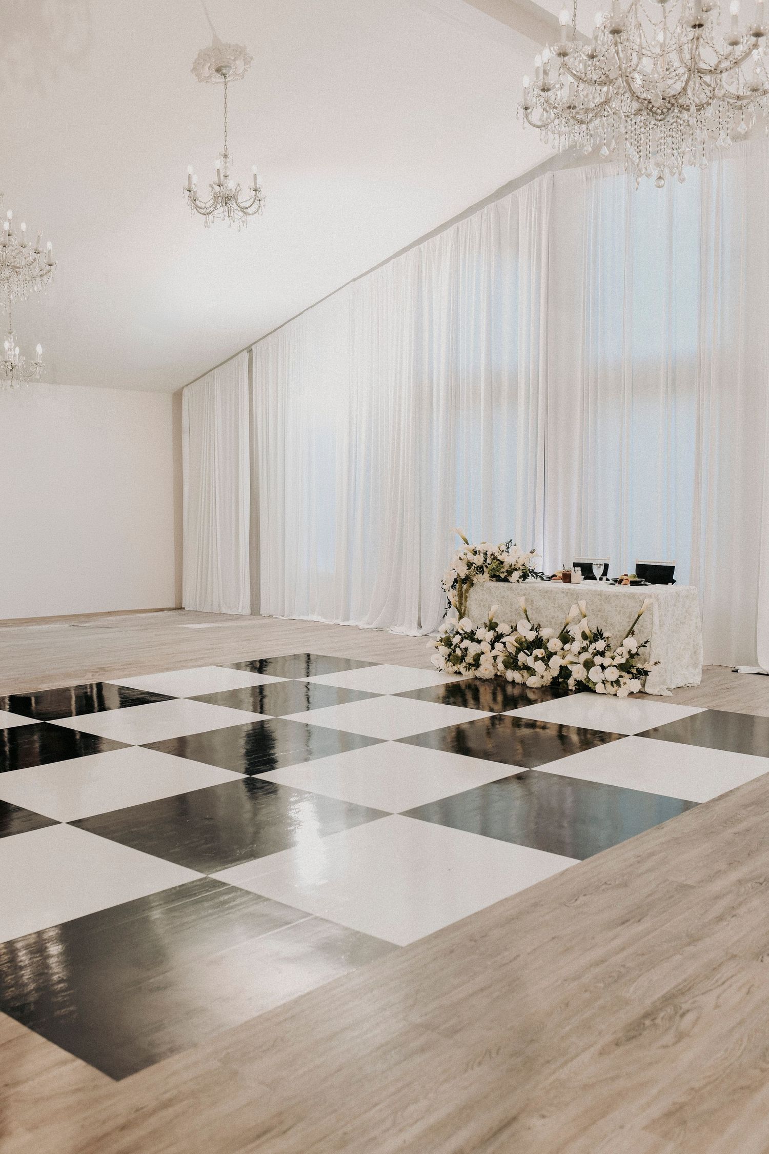Reception hall featuring black and white checkered dance floor
