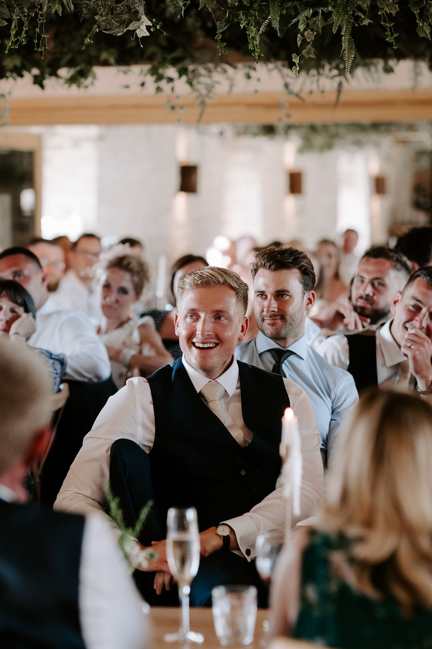 wedding guests laughing during speeches at yardspace old gore cirencester