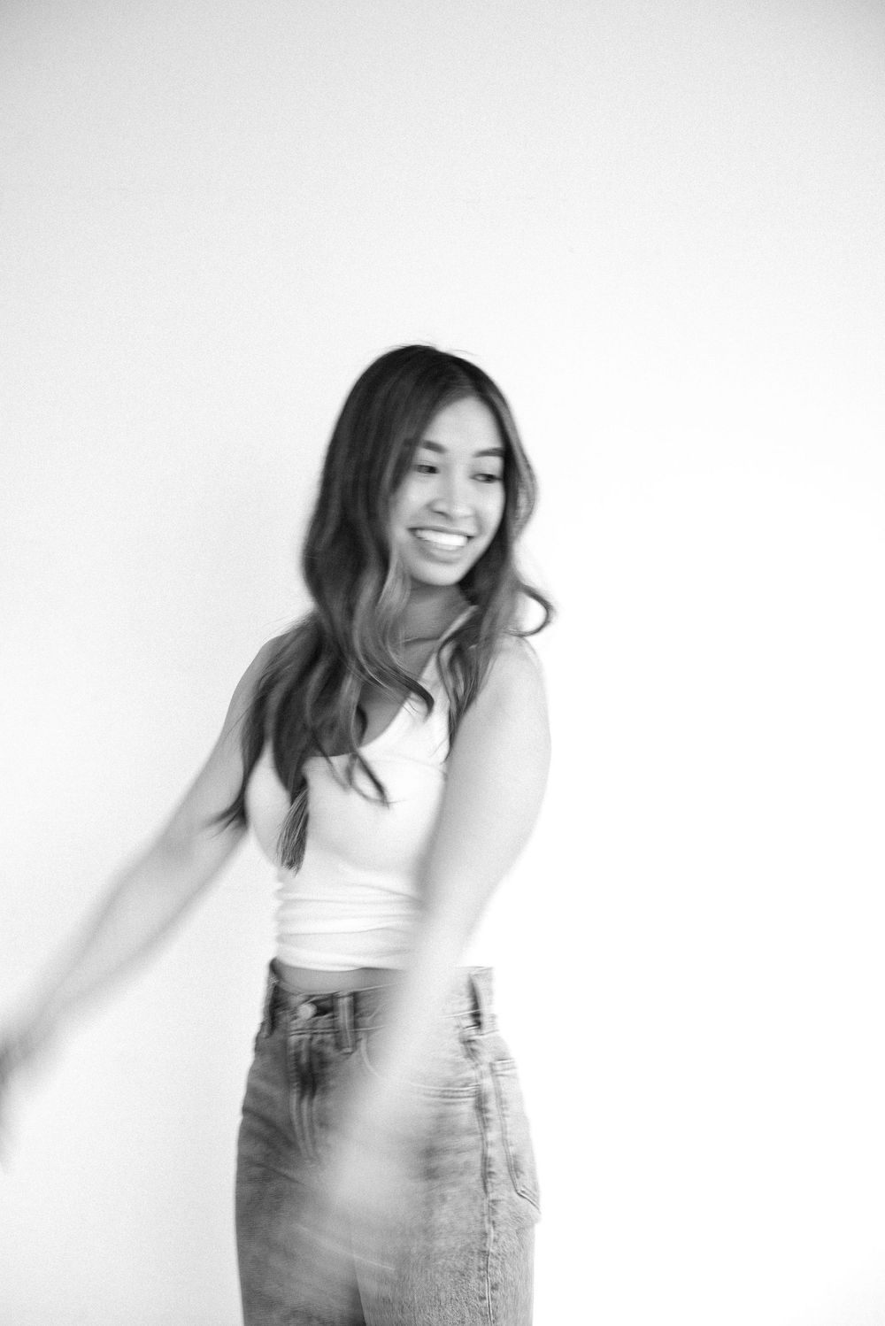Black and white photo sequence showing energetic dance movements in casual attire against white background.
