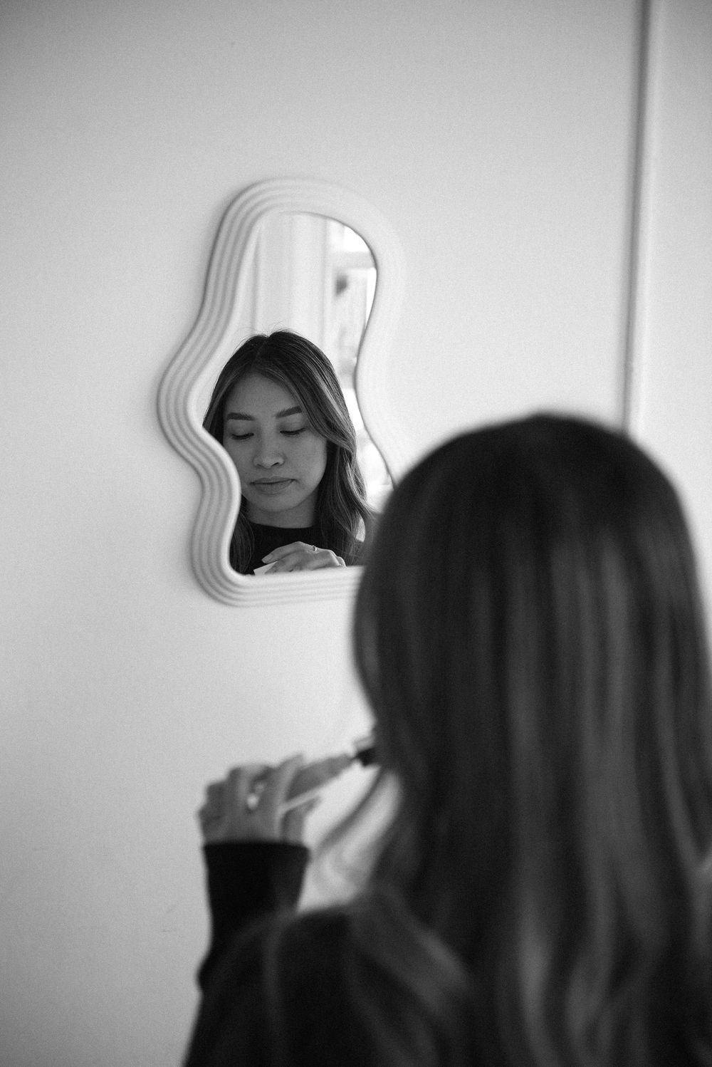 Black and white sequence captured through a wavy mirror showing various expressions.