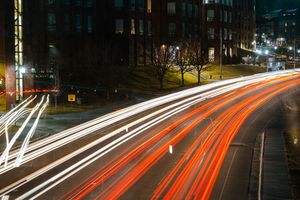 Long exposure of cars going by under bridge