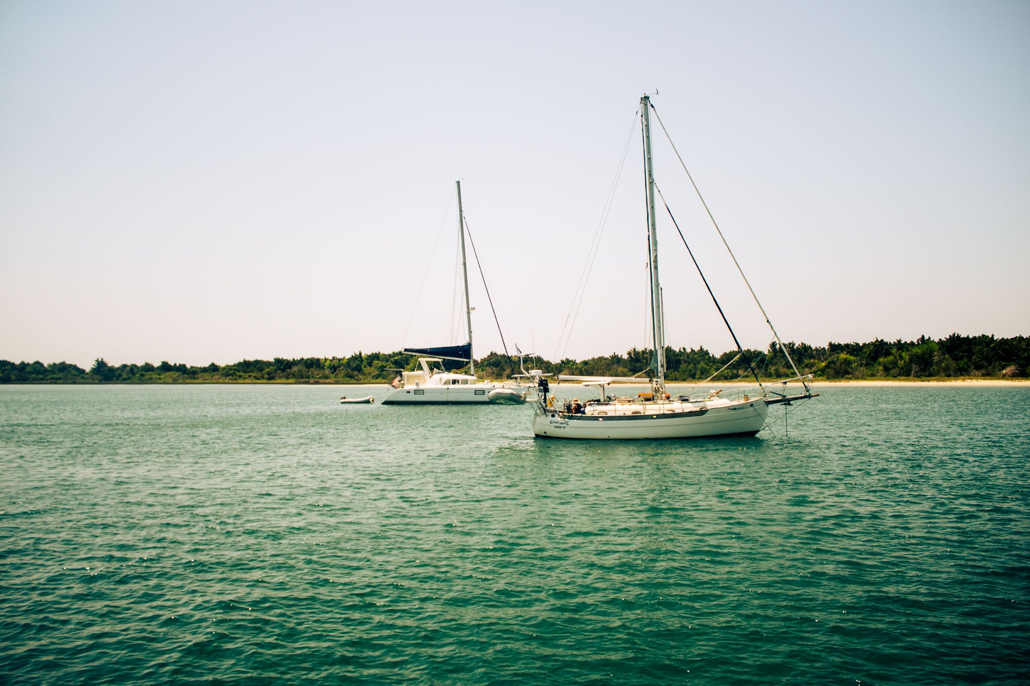 Sail boats in the ocean at dawn