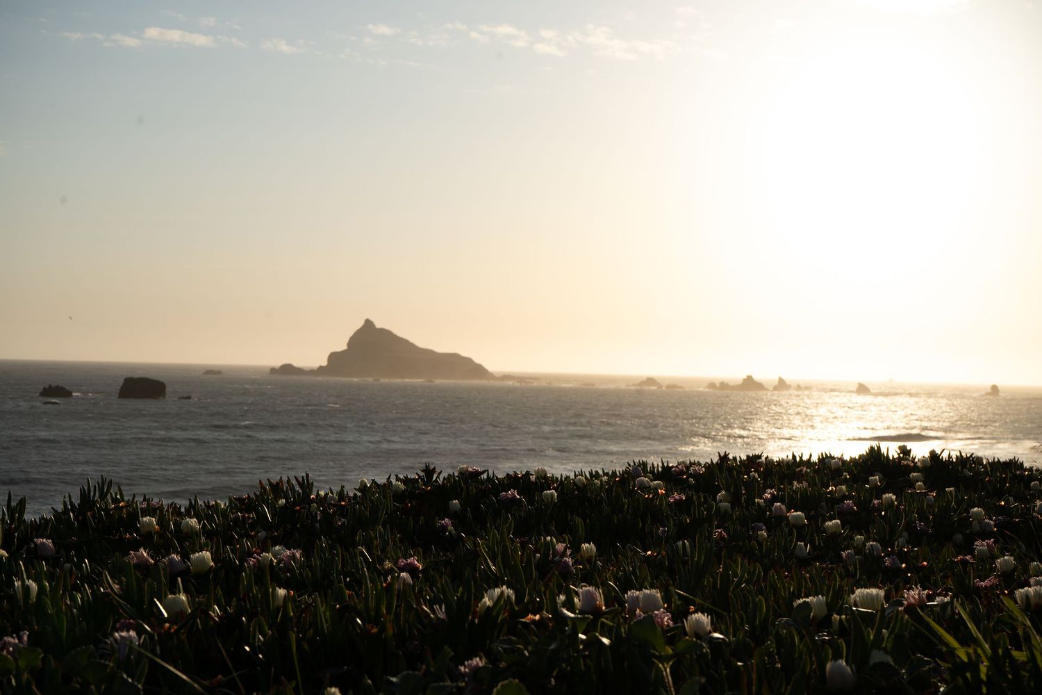 A series of scenic coastal landscape photos showing a mountain peak and ocean views at sunset.