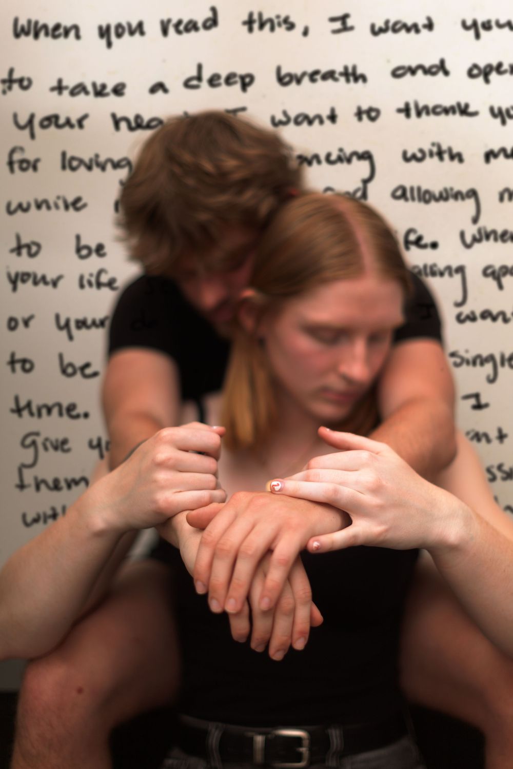 A portrait of two people with handwriting in the background