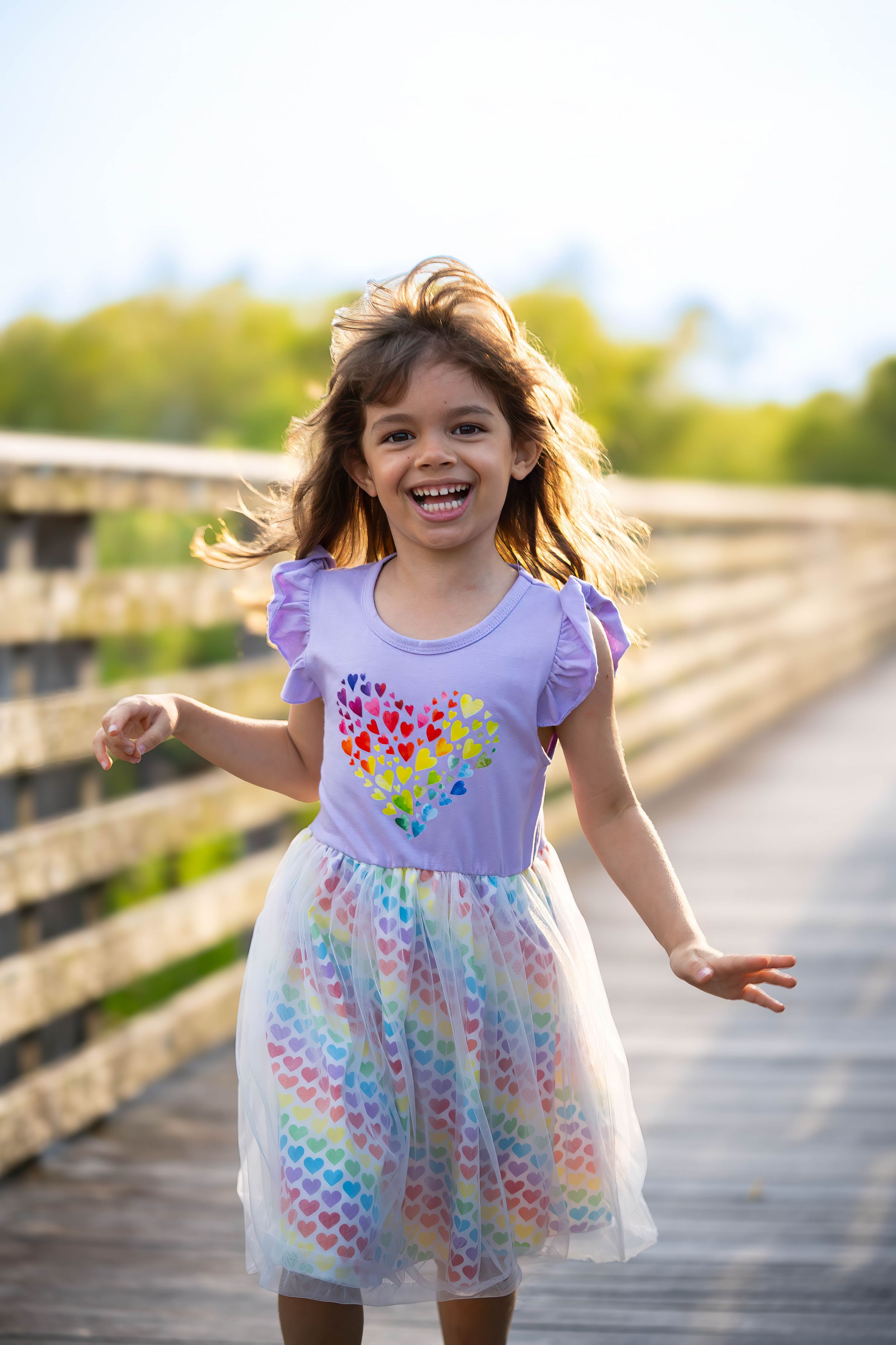 Evelyn playing on the boardwalk during a family session on juno dunes natural area in juno beach florida