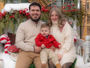 Coordinated family Christmas photos with red and neutral colored outfits against holiday decorations.