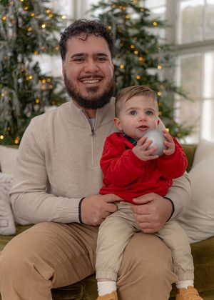 A heartwarming holiday portrait in front of a decorated Christmas tree.