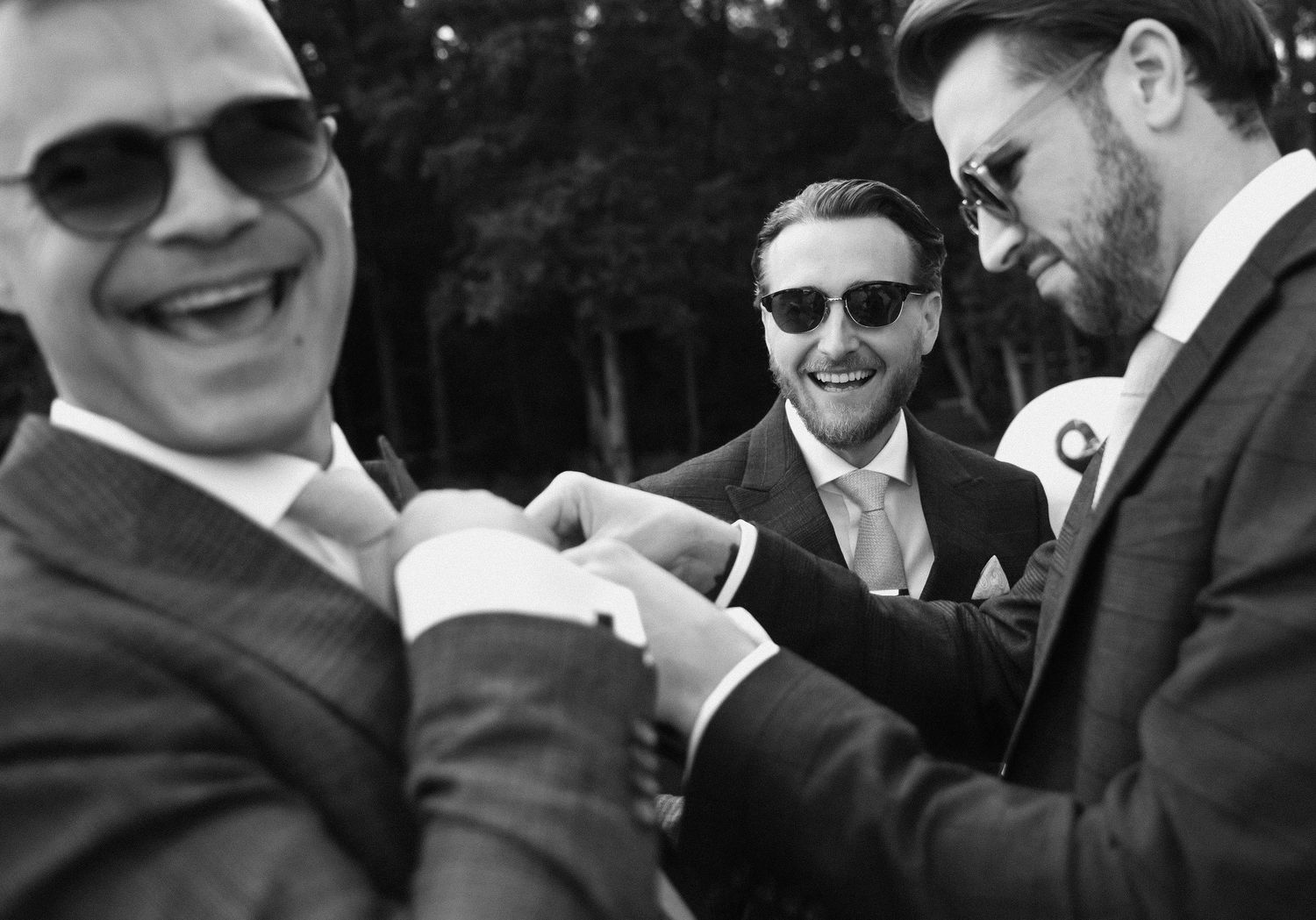 A black and white photo montage showing people in formal attire smiling and interacting at a social event.