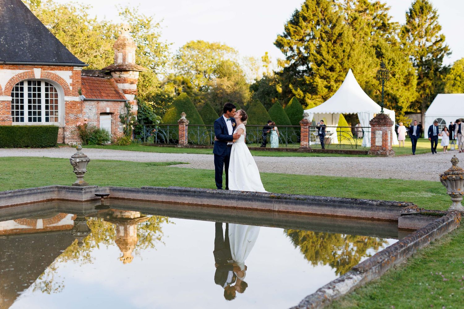 Elegant wedding venue with reflecting pool and autumn foliage.