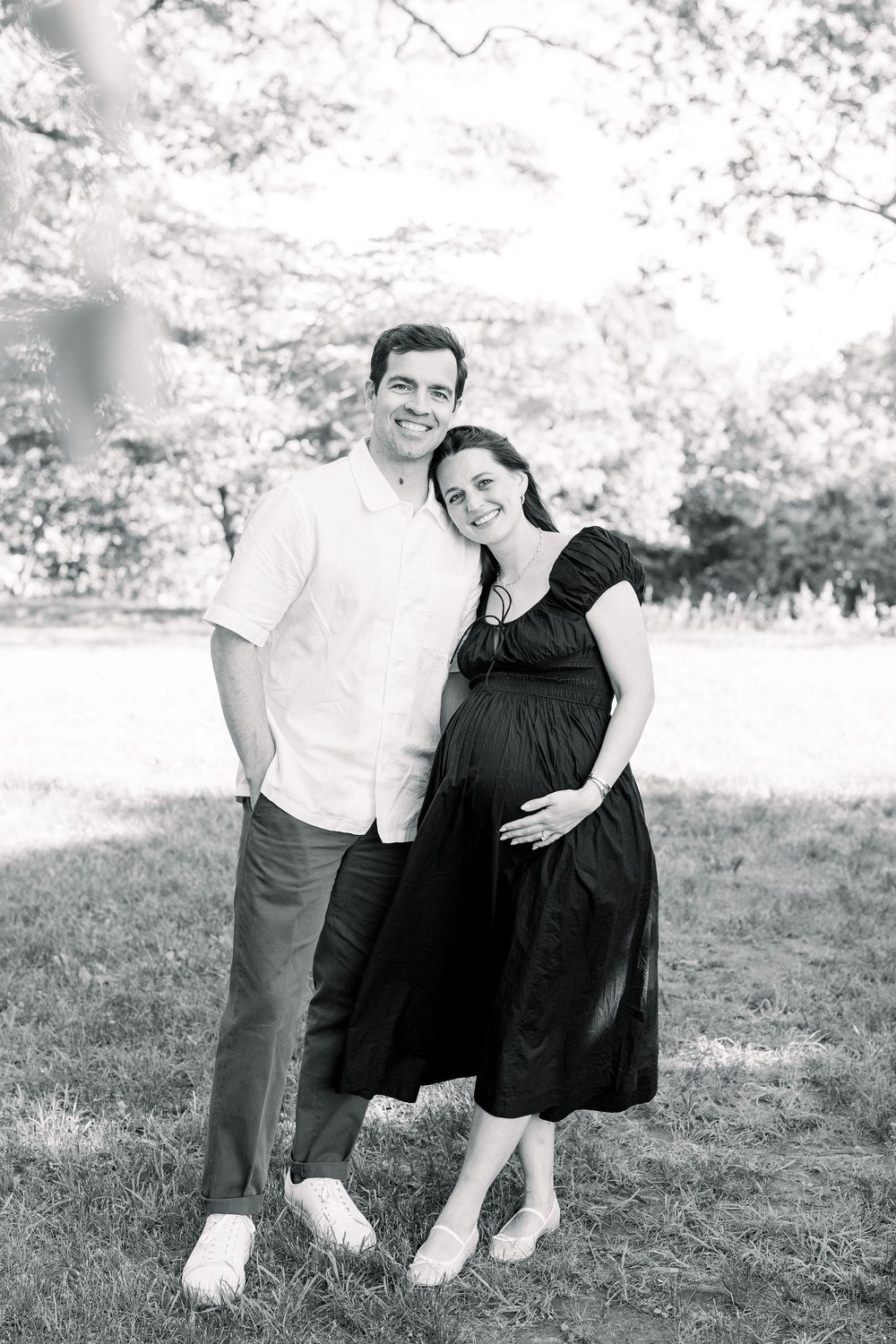 A playful black and white photo sequence showing a couple in casual attire posing together outdoors on grass.