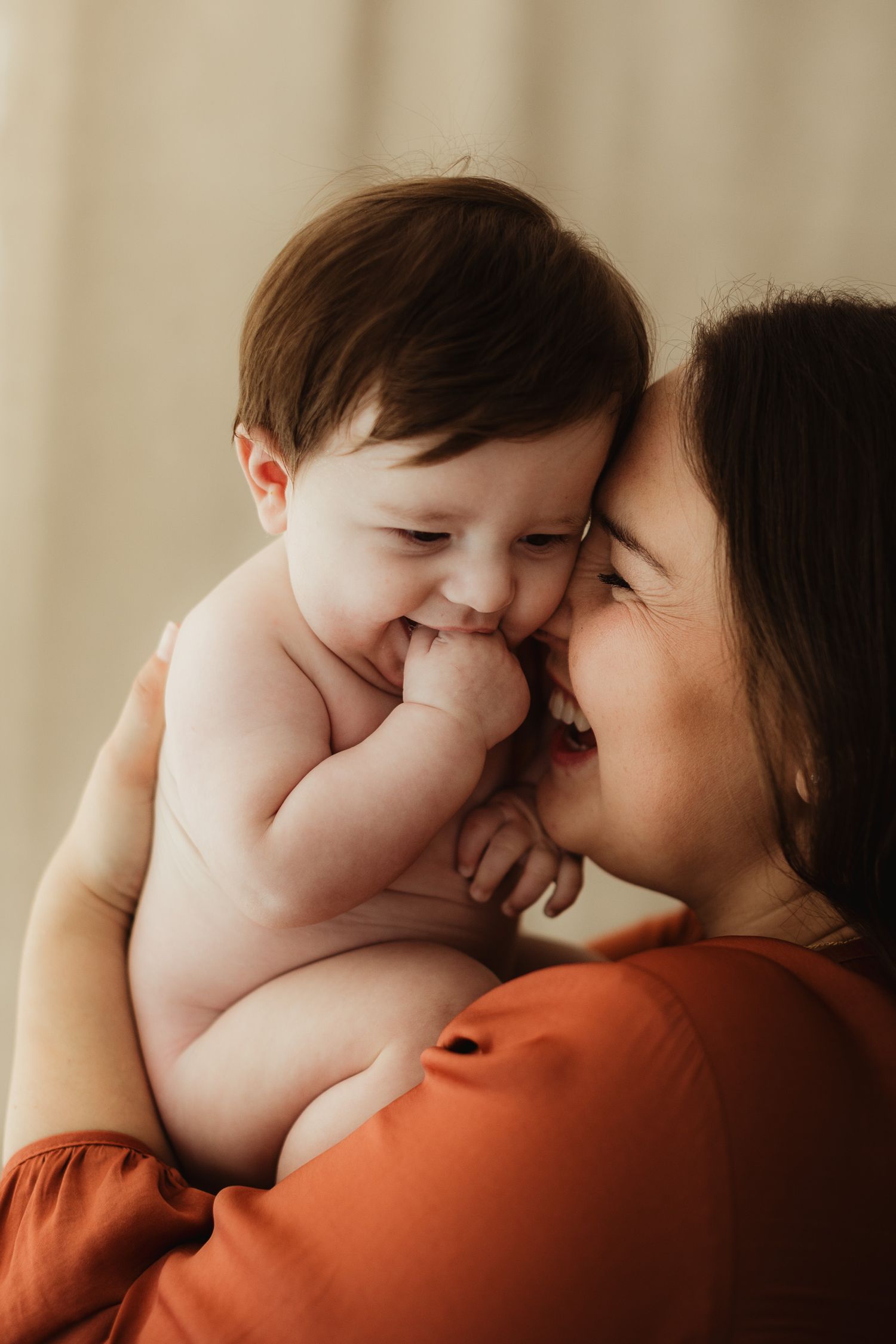 Warm-toned portrait series showing tender moments between parent and child.