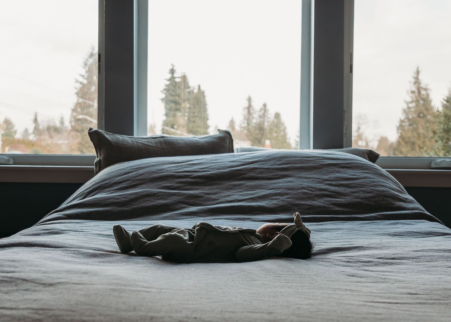 A sequence of photos showing an unmade bed with dark gray bedding against a window in natural light.
