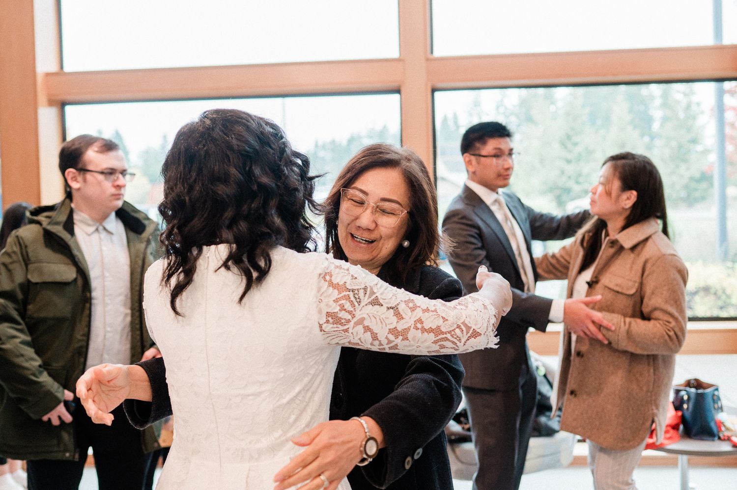 Wedding guests celebrate and hug together