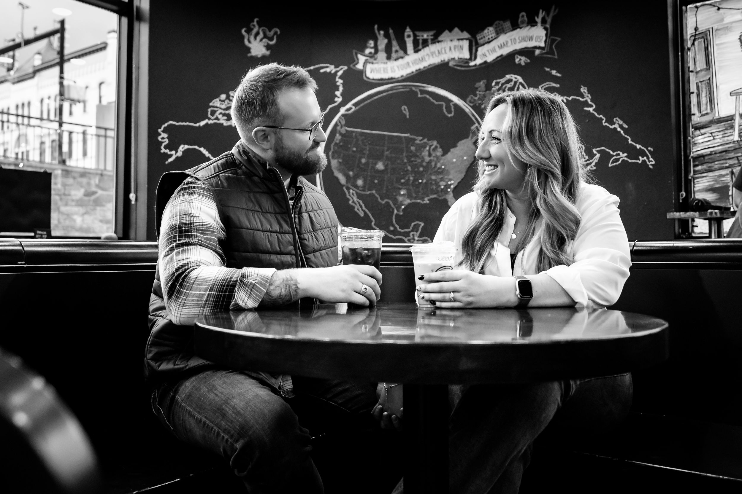 A black and white photo series showing couples sitting at bars and tables in intimate conversation.