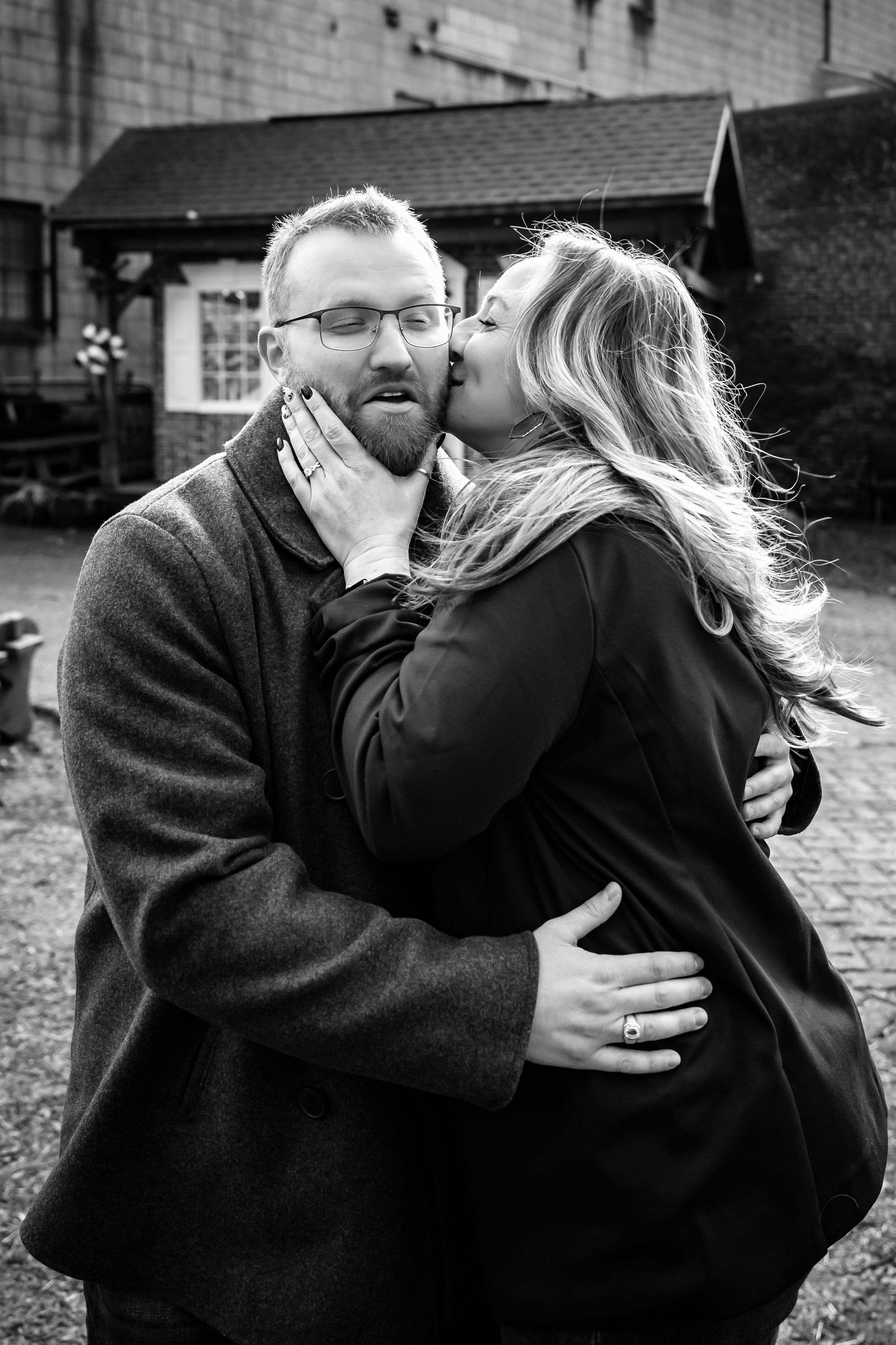 Black and white photo series capturing tender moments between couple in urban setting.