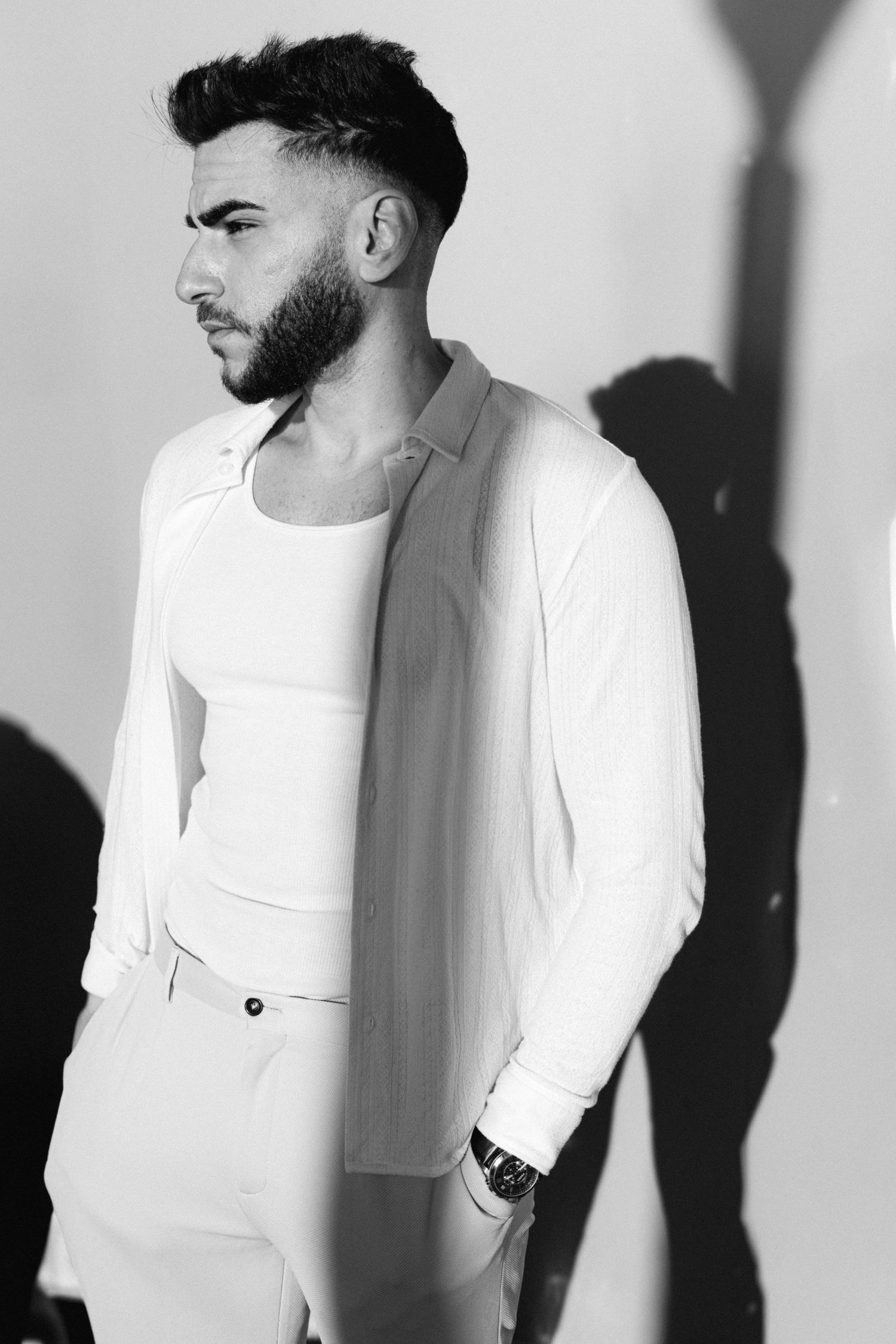 Black and white portrait series showing profile views of a person in a white t-shirt against a light background.