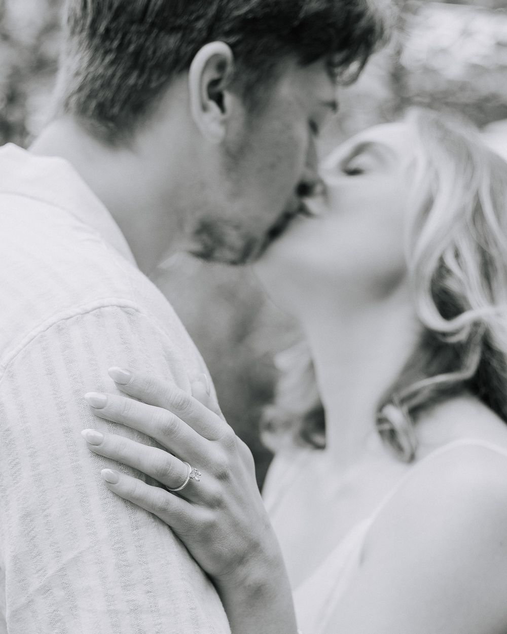 Intimate black and white close-up shots of a couple sharing tender moments.