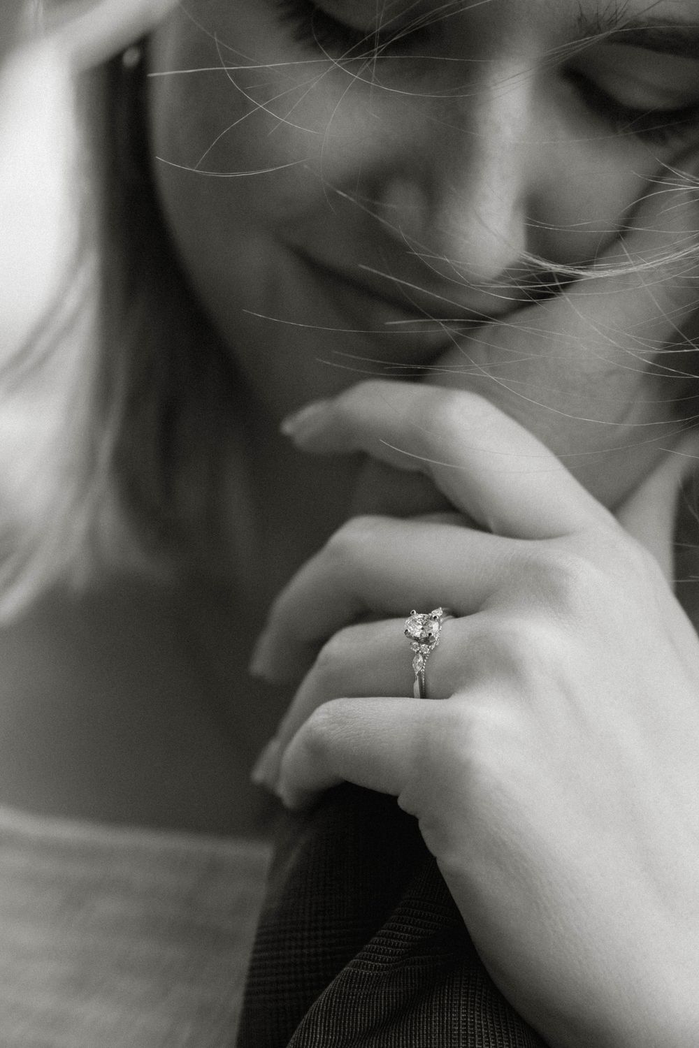 Close-up black and white photo series showing intimate romantic moments and an engagement ring.
