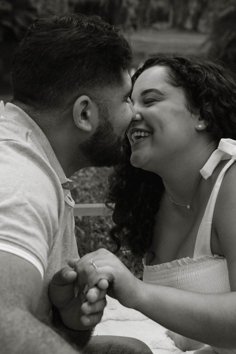 A black and white photo sequence captures playful romantic moments between a couple.