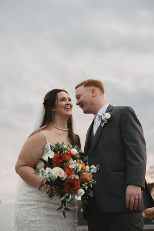 Candid wedding moments showing joyful laughter and embraces between the newlywed couple.