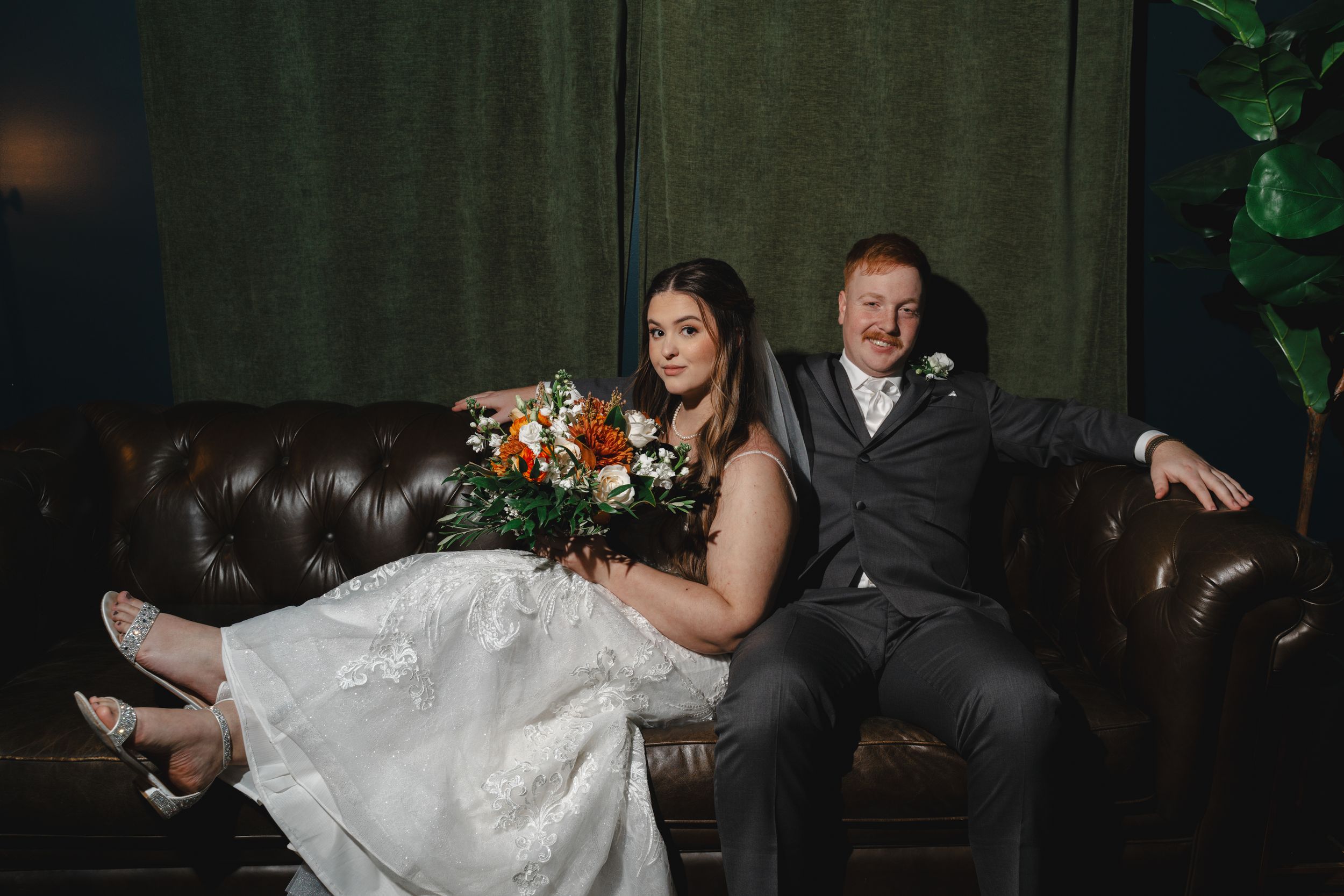 Dramatic wedding dance photos showing dynamic movement and poses in a dimly lit venue.