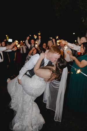 Wedding celebration at night with sparklers creating a magical atmosphere on the dance floor.