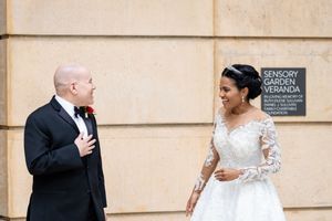Elegant wedding couple sharing romantic moments in a classic architectural setting.