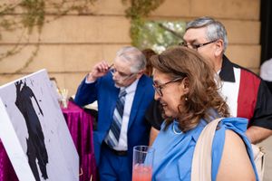 Wedding guests in colorful attire mingling during an outdoor reception.