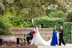 Garden wedding venue with stone walls and green landscaping creating a romantic outdoor setting.