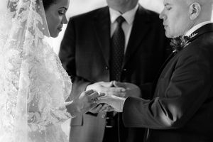 Black and white photo of intimate wedding ceremony moment.