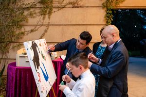 Wedding guests signing a guestbook at an elegant reception venue.