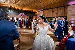 Rustic wooden ceiling reception hall decorated with ambient lighting for a wedding celebration.