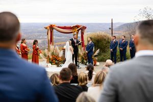 Outdoor wedding ceremony setup on a mountain overlook with rustic floral arch and guest seating. Sparta New Jersey Wedding Photographer