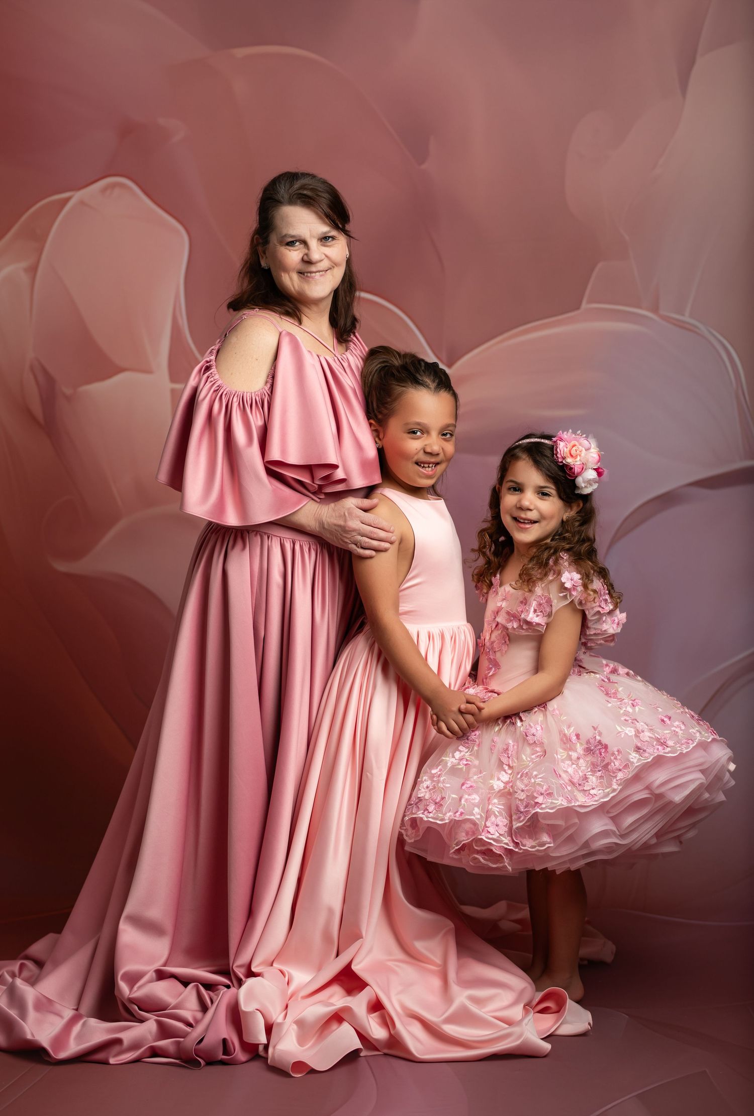 Delicate pink tulle fabric creates ethereal layers with soft folds and gentle textures in a dreamy composition.