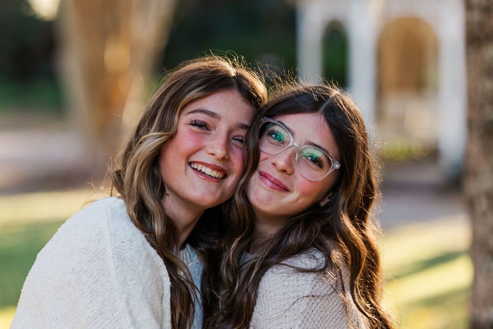 Two friends share joyful moments together outdoors in a series of candid photos showing genuine laughter and connection.