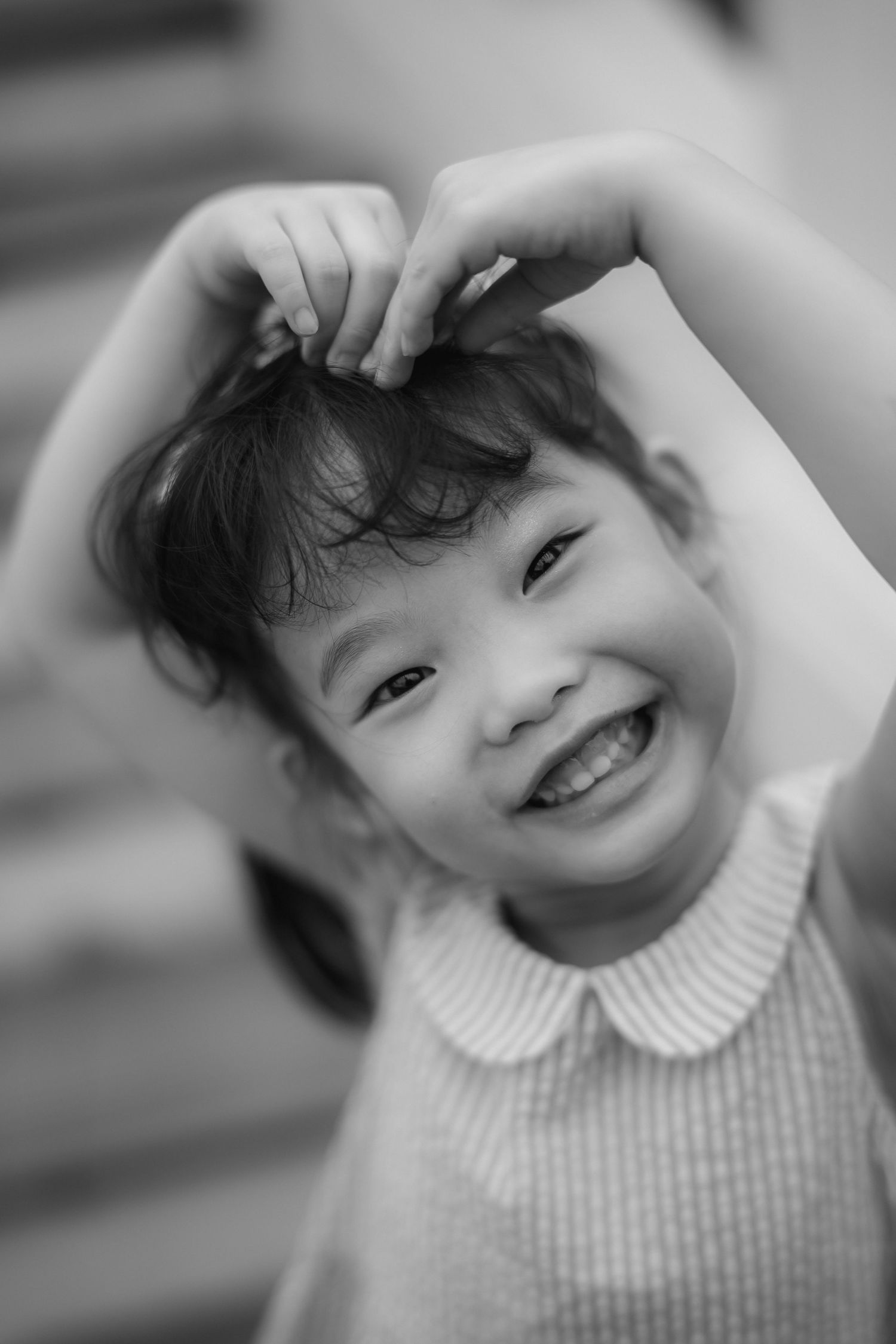 Black and white close-up portraits showing joyful expressions and a peter pan collar.