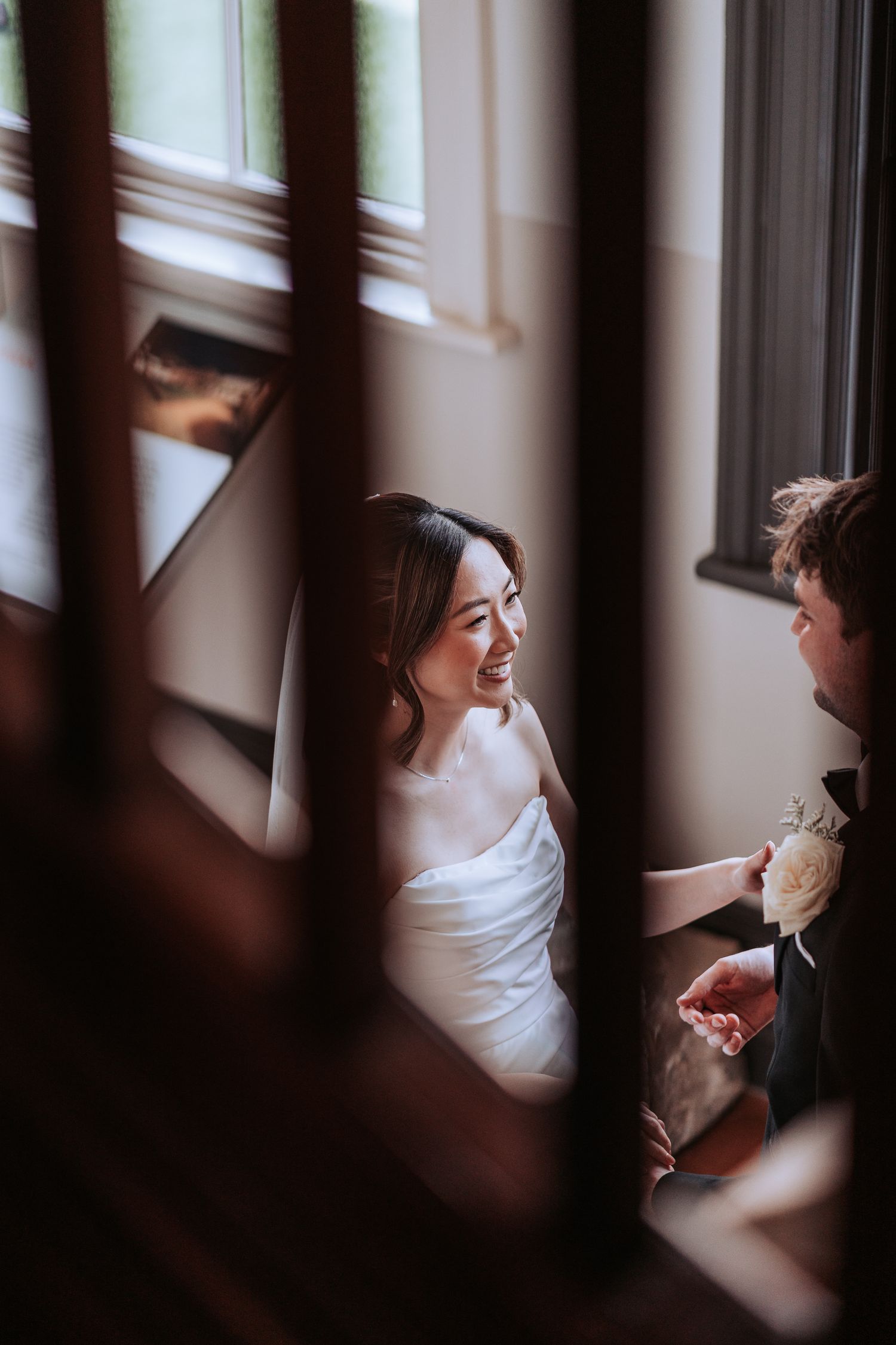 An intimate wedding moment captured through architectural details with warm lighting.