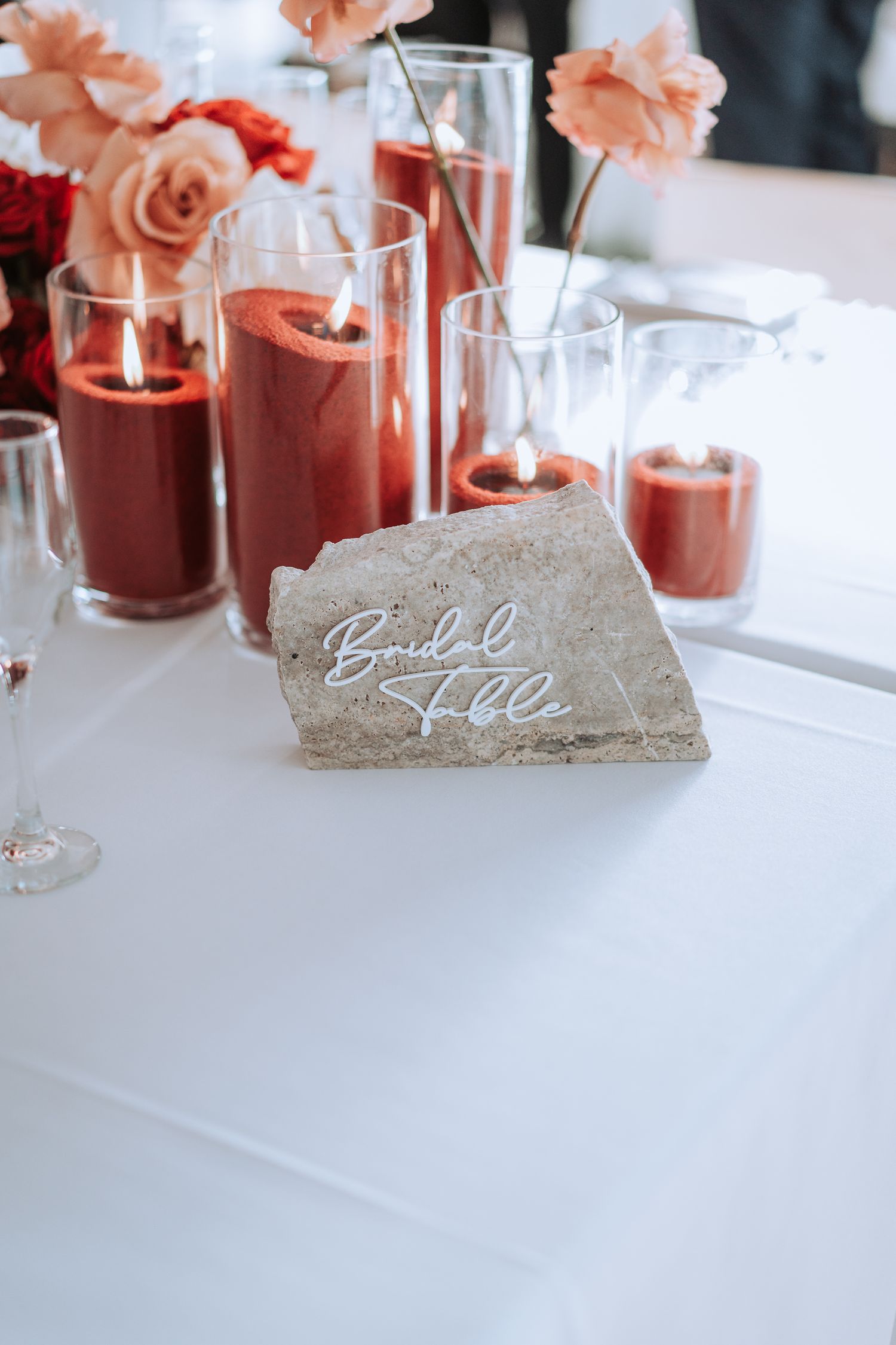Wedding table decor with pink drinks and floral centerpiece.