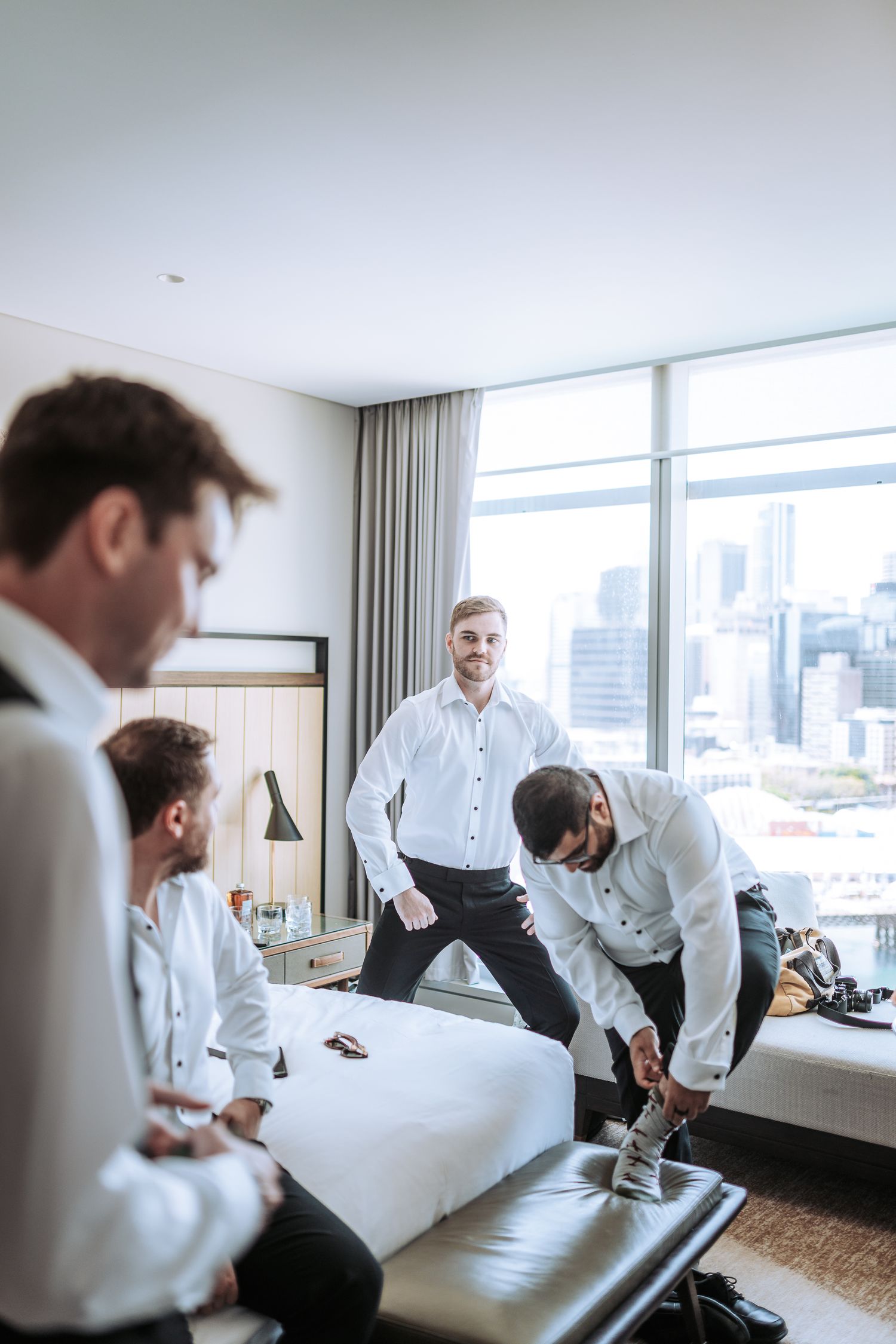 People in white shirts having an informal gathering in modern hotel setting.