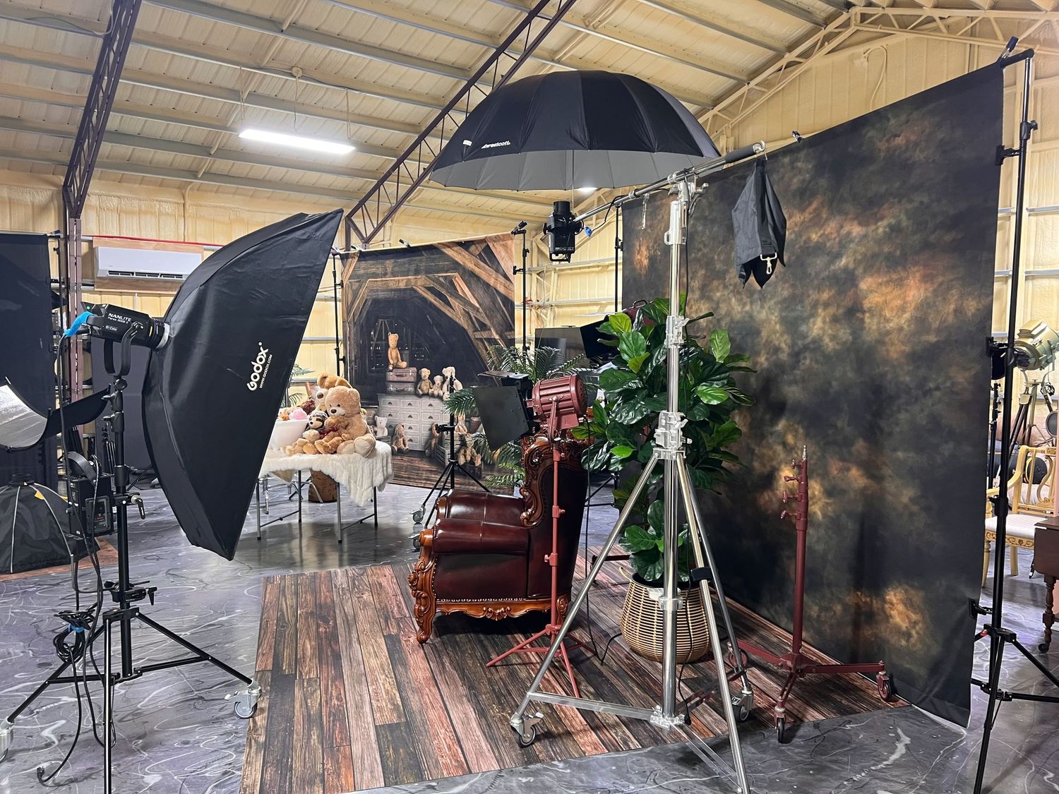 Studio lighting setup with antique chair and dark moody backdrop for professional photography.