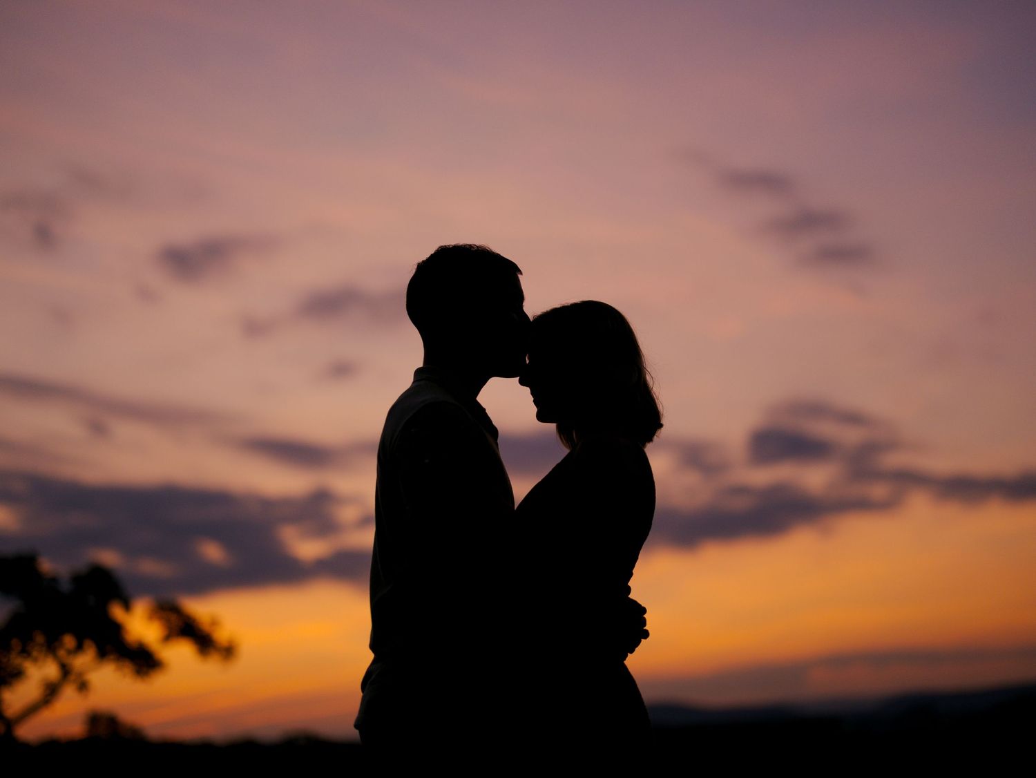 Seven romantic silhouettes in dramatic sunset lighting show couples embracing and sharing intimate moments.