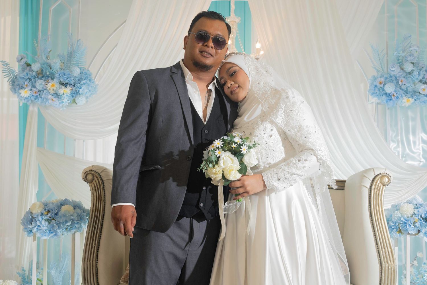 A romantic wedding celebration in an elegant room decorated with blue floral arrangements.
