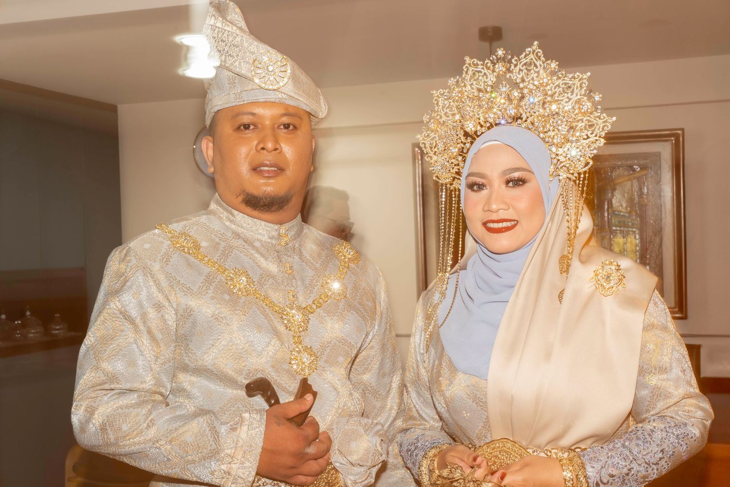 A traditional wedding couple in white and gold attire poses together in multiple ceremony photos.
