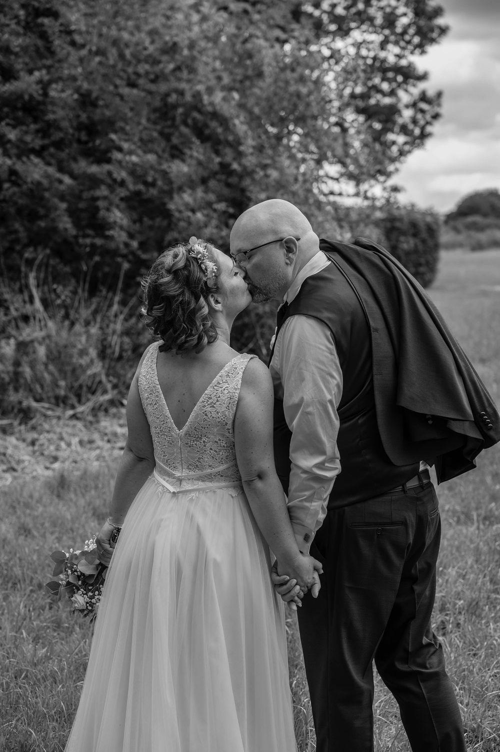 A romantic outdoor photography sequence shows a couple sharing tender moments while standing in a grassy meadow.