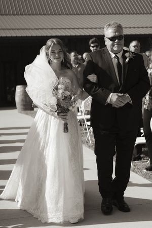 Black and white wedding photos showing tender moments between wedding party members.