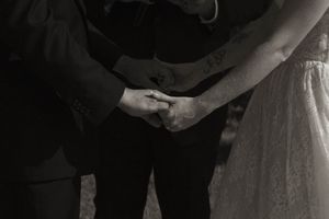 Close-up details of wedding ceremony with white dress and formal attire.