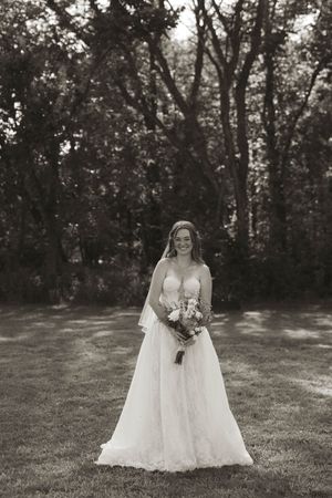 Black and white bridal portraits in an elegant lace wedding gown with bouquet.